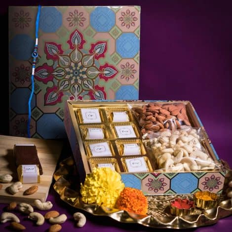 Rakhi gift pack for brothers with chocolates, dry fruits, and a Rakhi thread.